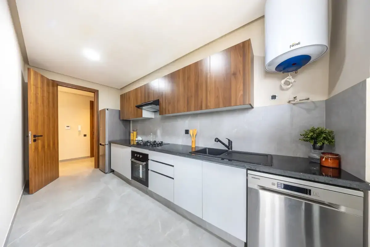 Modern fitted kitchen with wood cabinetry and grey finishes