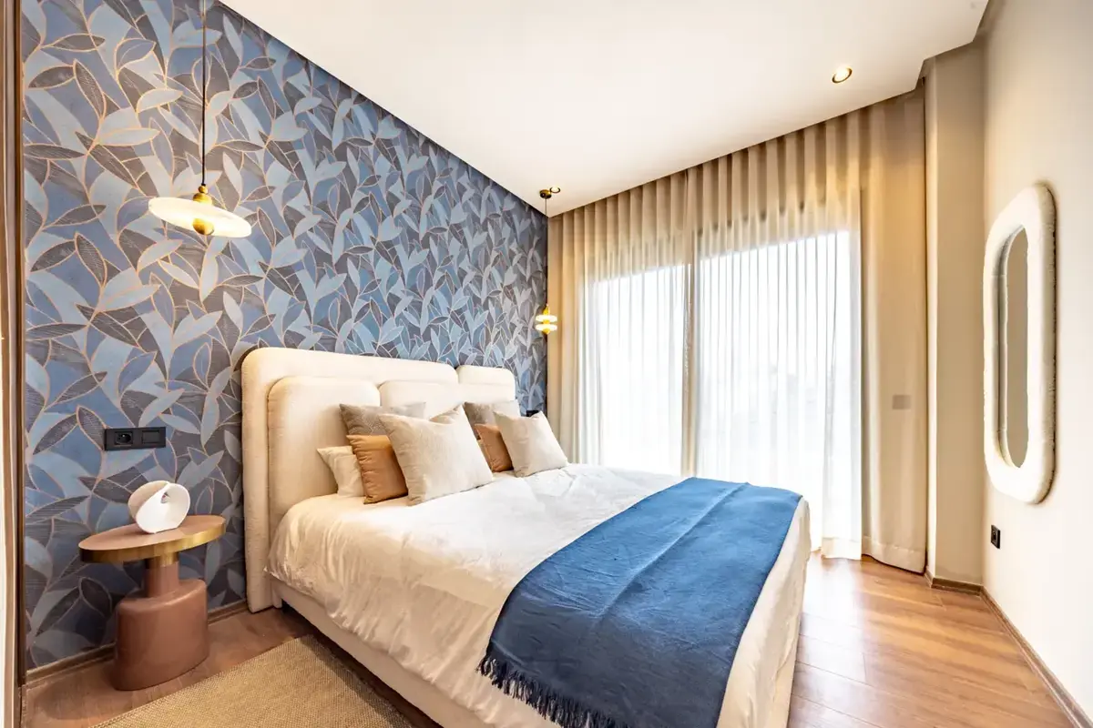 Blue-accent bedroom with botanical wallpaper
