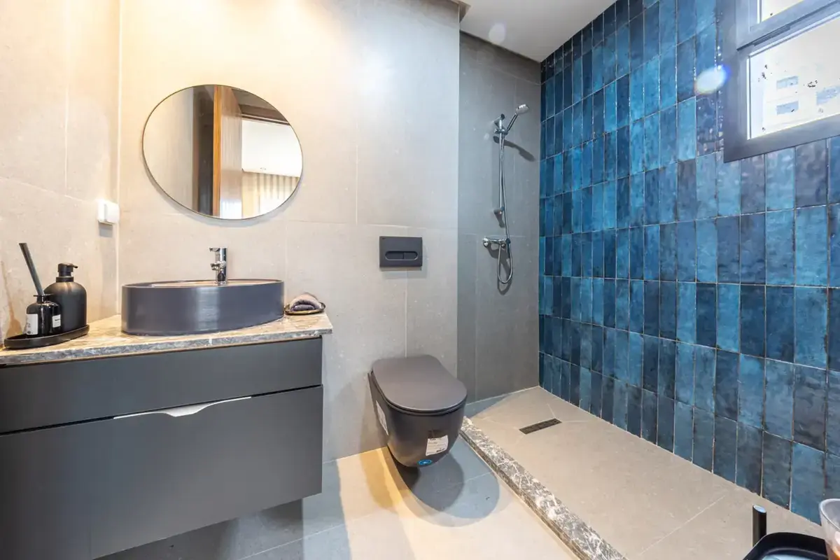 Modern bathroom with deep blue tile feature wall